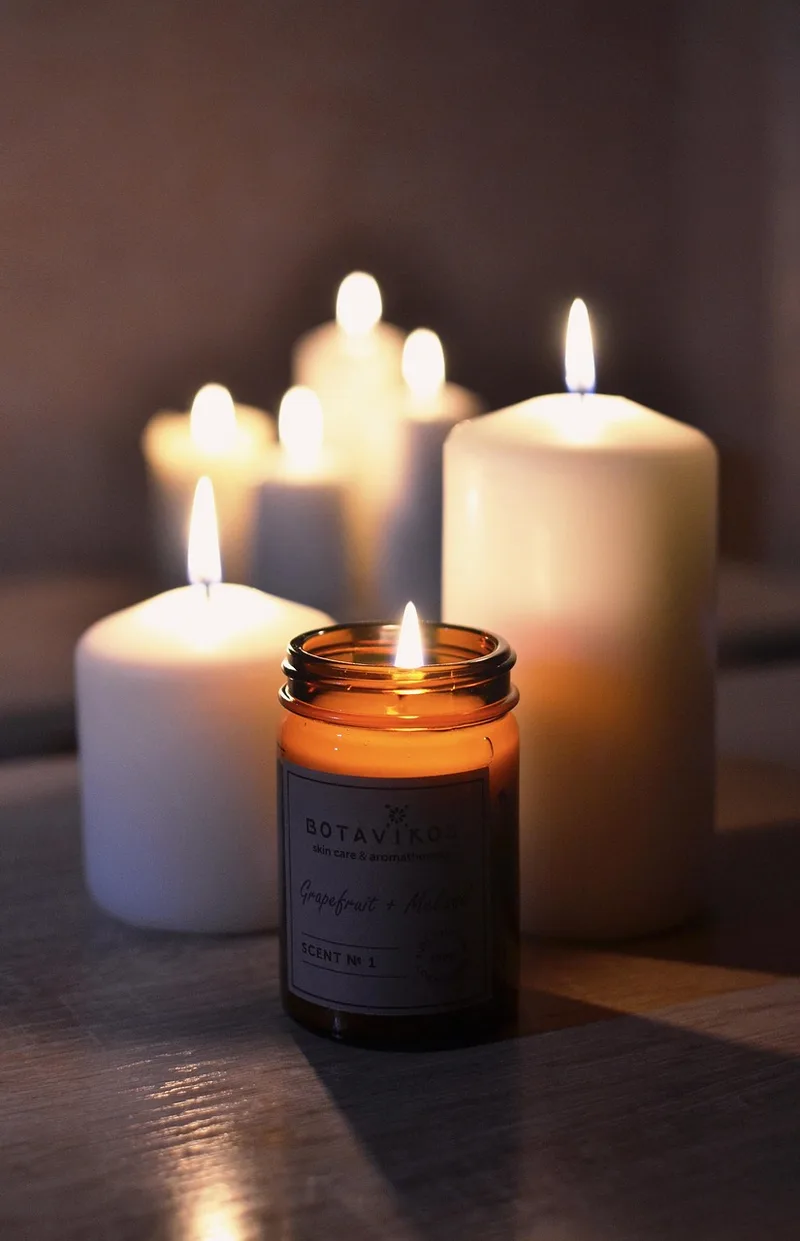Spa candles and relaxation items arranged in soft warm light, setting a calm and private tone for first-time buyers