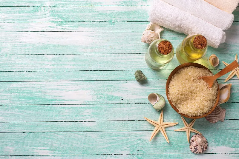 Skincare and natural oil products arranged as a spa flatlay, representing lubricant ingredients and material compatibility
