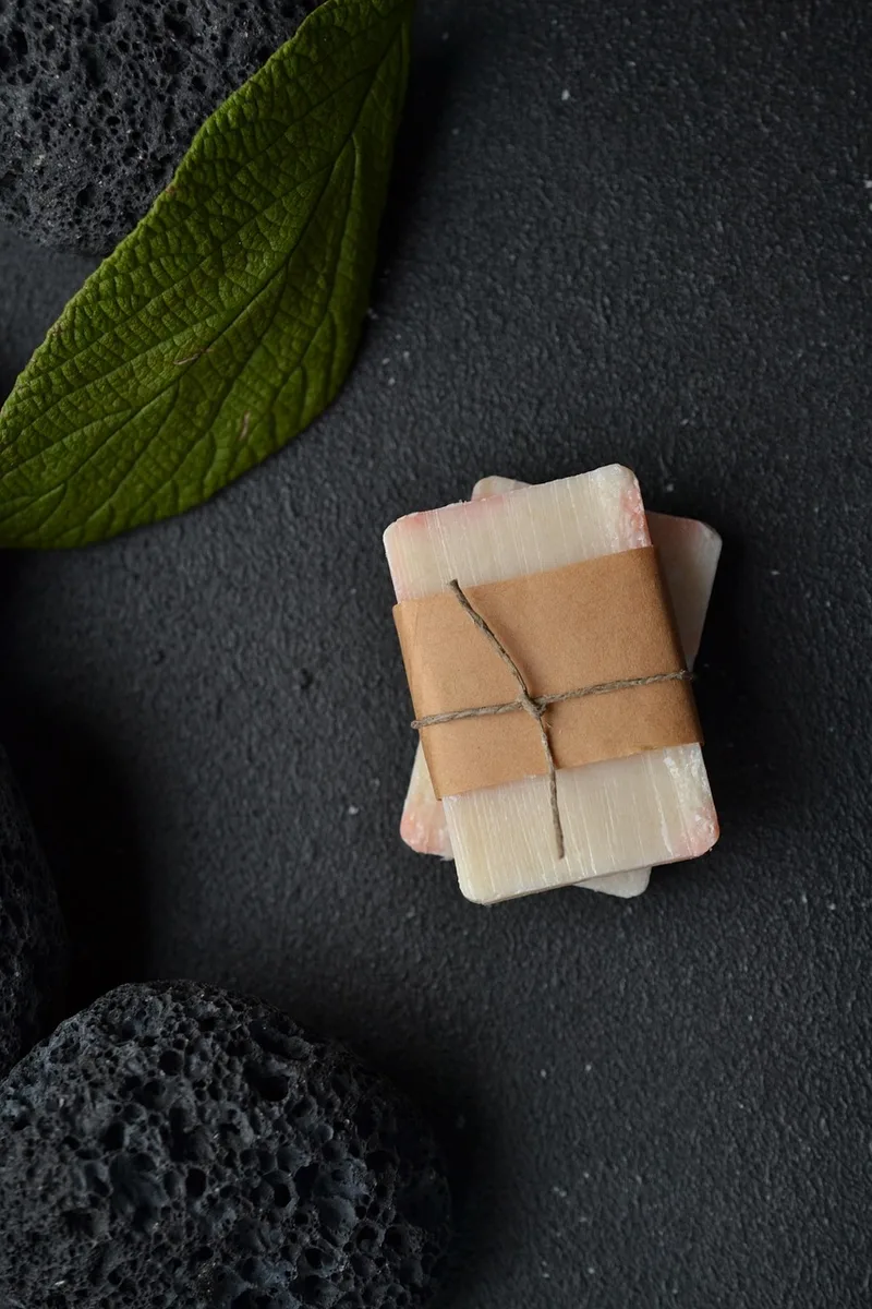Handmade pastel soaps and hygiene products arranged as a clean flatlay, illustrating a simple toy-cleaning routine