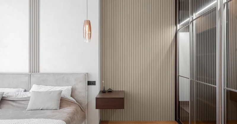 A modern minimalist bedroom with warm neutral tones and soft natural light, conveying privacy and comfort for a first-time buyer