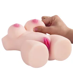 Hand pressing one breast on the TPE torso to show how soft the material feels
