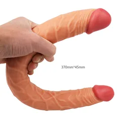 Flesh-toned double-ended realistic dildo bent in one hand showing both glans ends and its full length