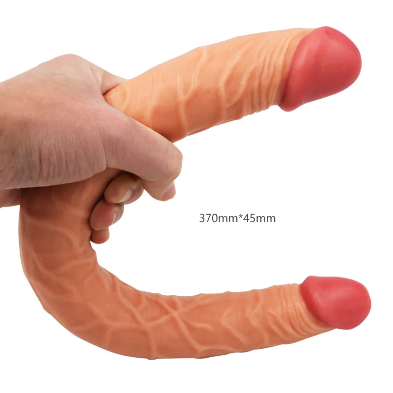 Flesh-toned double-ended realistic dildo bent in one hand showing both glans ends and its full length