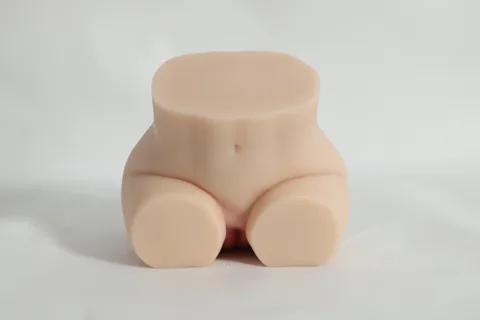 Front seated view of the realistic love doll showing crossed thighs and belly detail