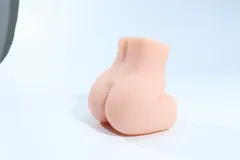 Compact butt masturbator resting upright on a flat surface to show its overall body shape