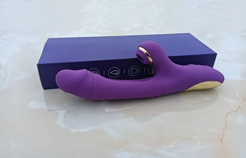 Close-up of rabbit-ear clitoral stimulator and gold metallic accents on the vibrator shaft