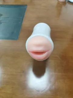Vibrating masturbator with the included heating rod beside it
