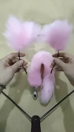 Pink faux fur fox tail anal plug with matching ear headband and collar from the three-piece role-play set