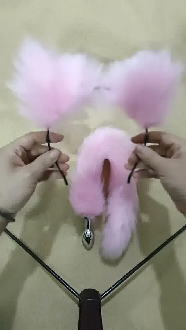 Pink faux fur fox tail anal plug with matching ear headband and collar from the three-piece role-play set
