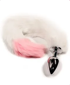 Close view of the faux fur fox tail curling away from the smooth chrome anal plug