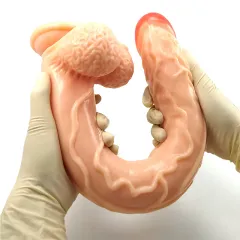 Gloved hands bending the silicone dildo into a deep curve to show its softness
