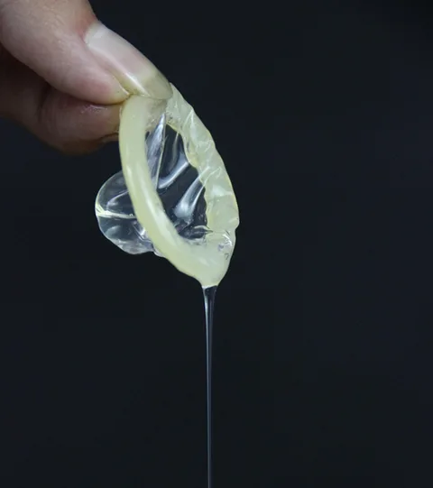 Microscopic detail of the condom surface showing the smooth lubricated coating