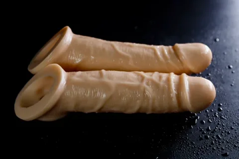 Realistic TPE penis sleeve in skin tone with bionic texture and hollow wearable design