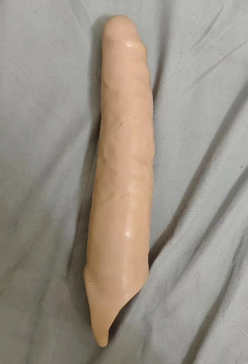 Flesh-coloured large spiked penis sleeve with textured shaft and tapered base