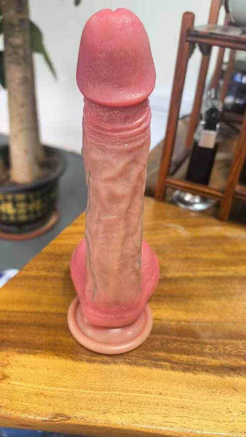 Realistic dildo smooth glans head detail shot