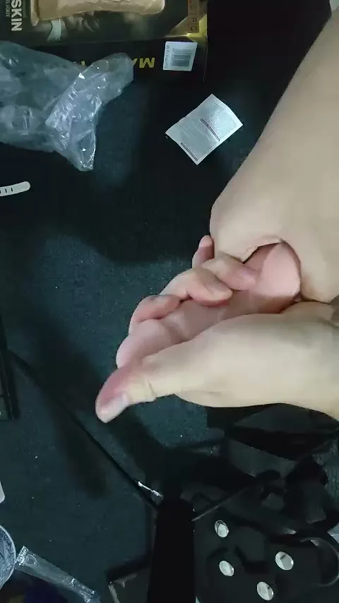 Bending the flexible realistic silicone shaft of the strap-on dildo