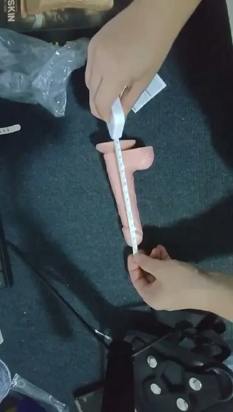 Ruler measuring the full length of the realistic silicone strap-on dildo
