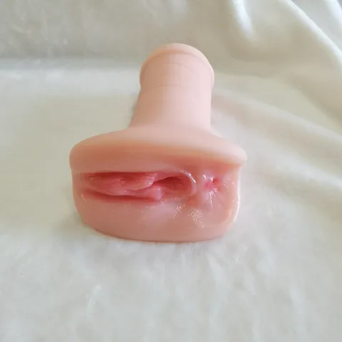 Dark red small labia adding natural color contrast to the design
