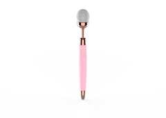 Vibrating makeup brush in pink showing brush head and slim handle