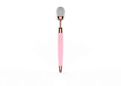 Vibrating makeup brush in pink showing brush head and slim handle