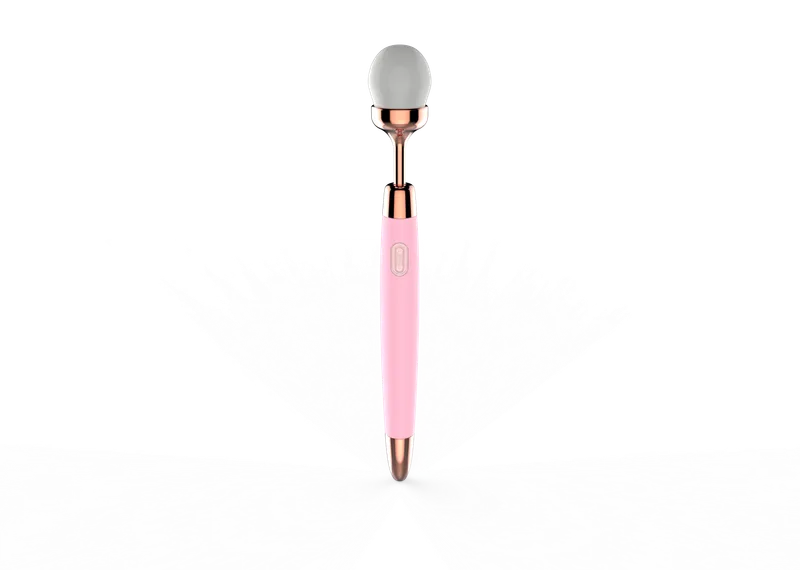 Vibrating makeup brush in pink showing brush head and slim handle