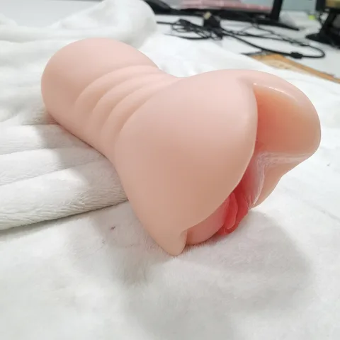 Handheld male masturbator shown at realistic scale