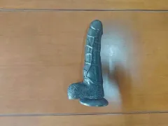 Black realistic dildo angled profile view