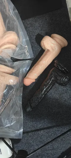 Suction cup base of the realistic dildo gripping a flat surface for hands-free positioning