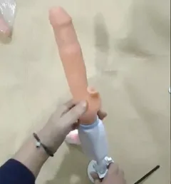 Veined jelly shaft and sculpted head of the thrusting dildo held upright on its suction cup base