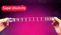 Spiked penis sleeve pulled to full extension against a pink background to show TPE stretch