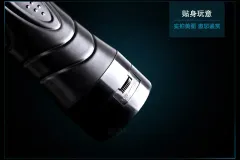 Close-up of the black vibrating masturbator cup entry opening and inner texture