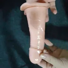 Close-up of the soft TPE dildo showing realistic veined texture and a defined glans